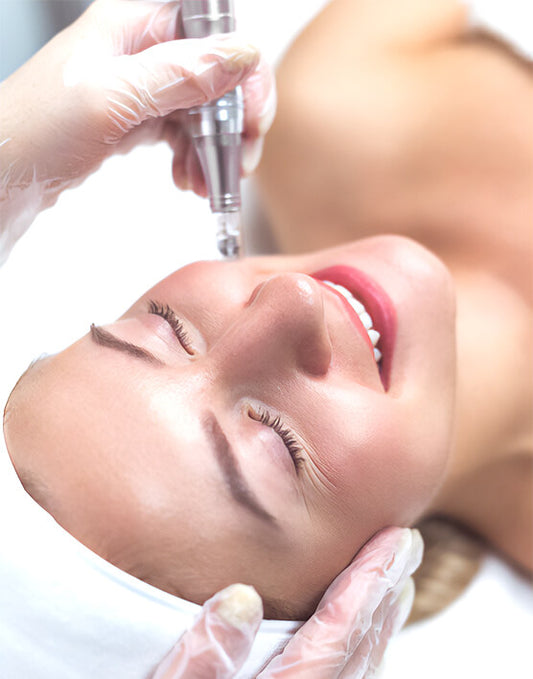 Woman receiving a cosmetic treatment with gloves on a beige background
